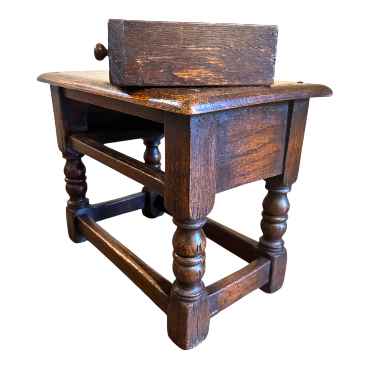 Antique carved oak joint stool side table with drawer removed, showing drawer construction and substantial solid oak frame
