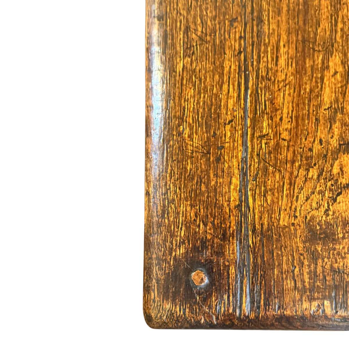 Close-up of antique oak tabletop showing extensive age-related wear, scratches, grain and rich warm patina