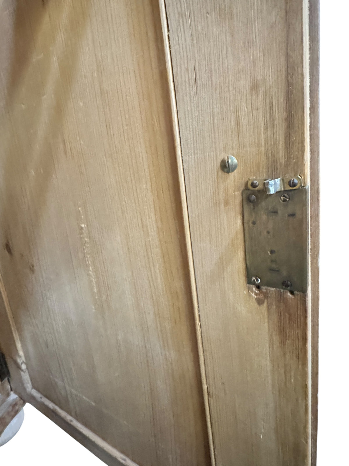 Close-up of original lock detail on an antique pine kitchen dresser showing aged metal hardware and pine surface.
