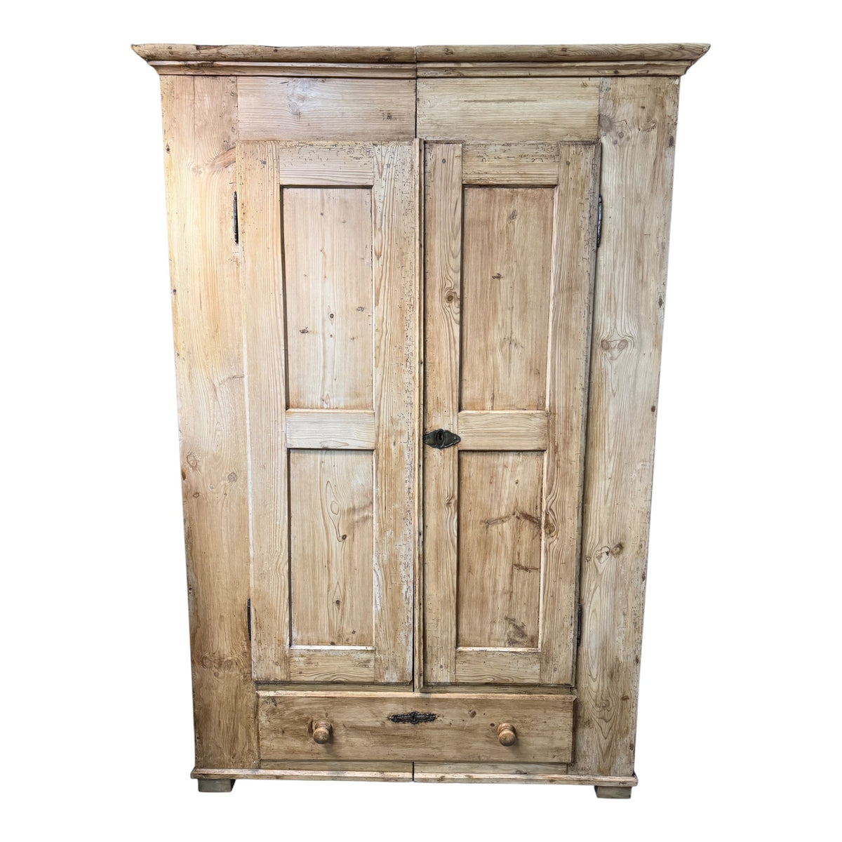 Antique Victorian pine two-door wardrobe with lower drawer, panelled doors and timeworn stripped pine finish