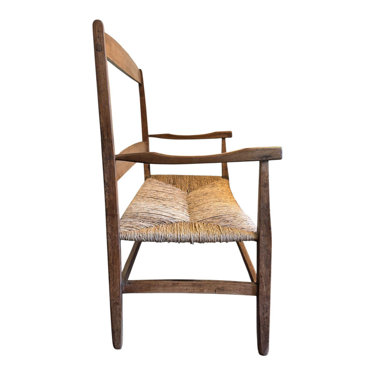 Angled view of antique c.1900 walnut and rush two-seater Arts & Crafts settee showing shaped arms and pegged frame