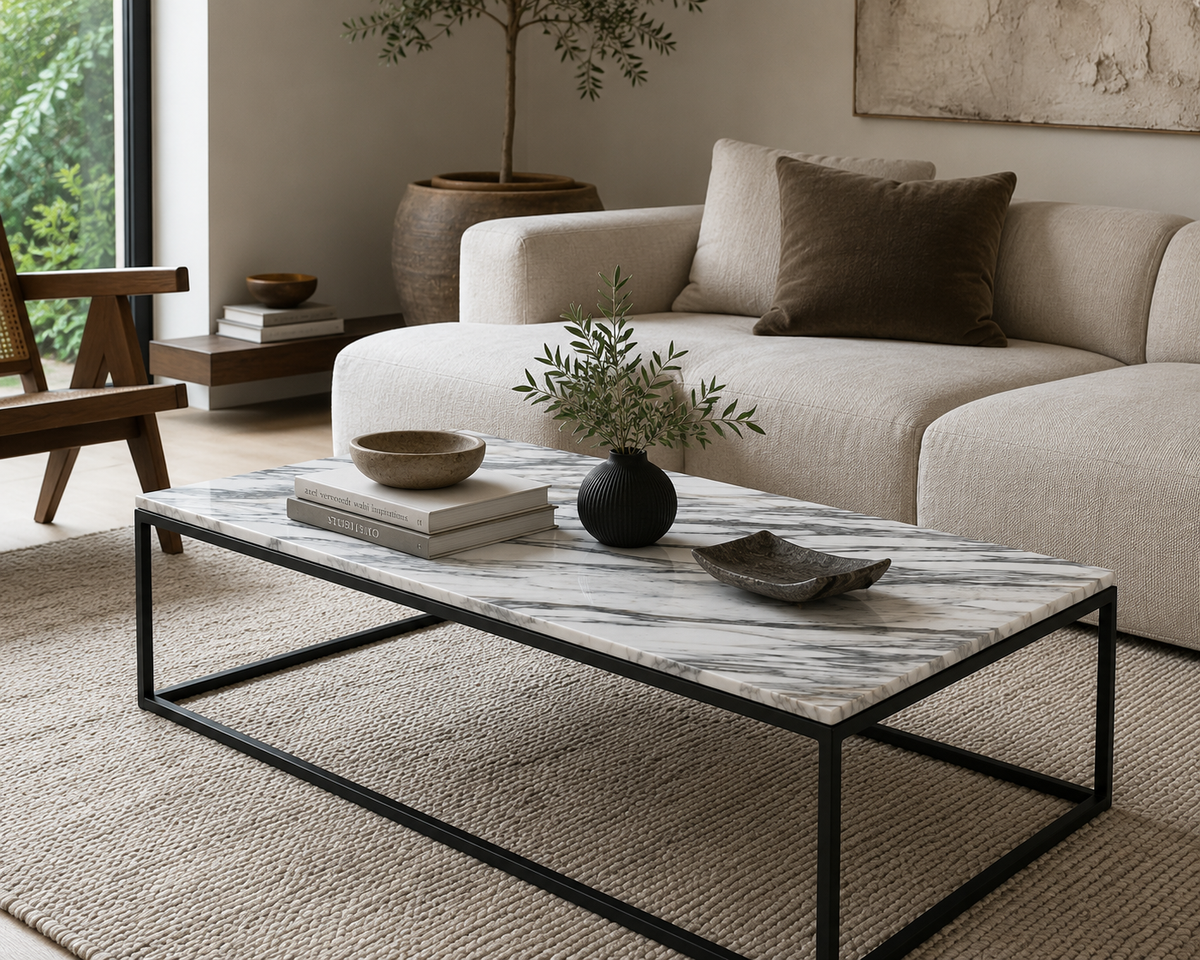 Contemporary Calacatta Vagli marble coffee table styled in a luxury modern living room with neutral furnishings and natural textures.