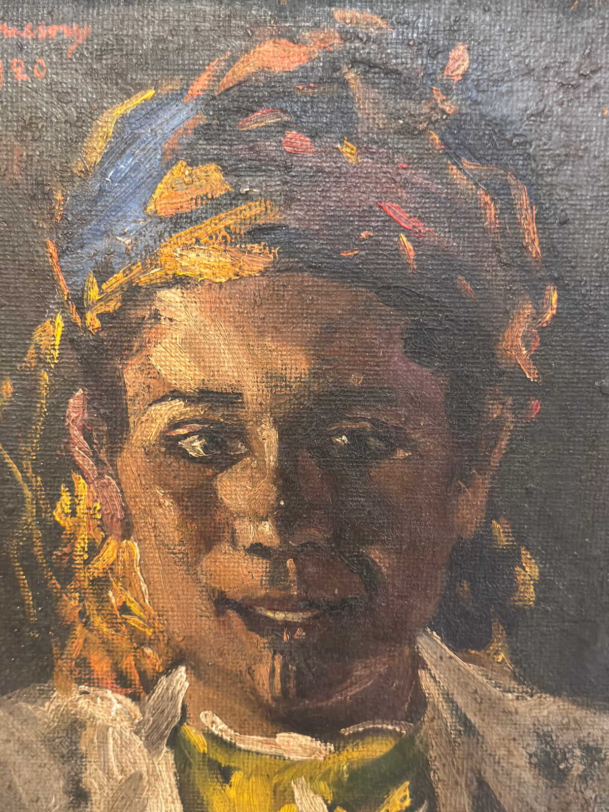 Close-up of the young sitter’s face and colourful headwrap, showing textured oil brushwork and warm highlights.