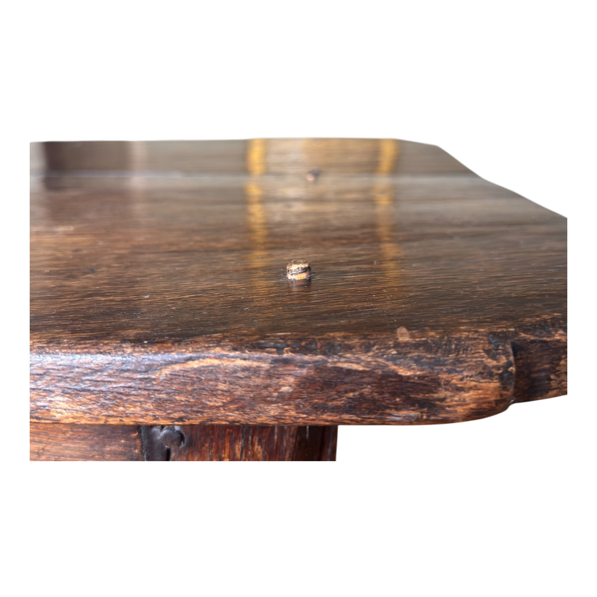 Close-up of the thick oak tabletop edge showing hand-worked texture, wear, rounded corners and the open joint between the two boards.