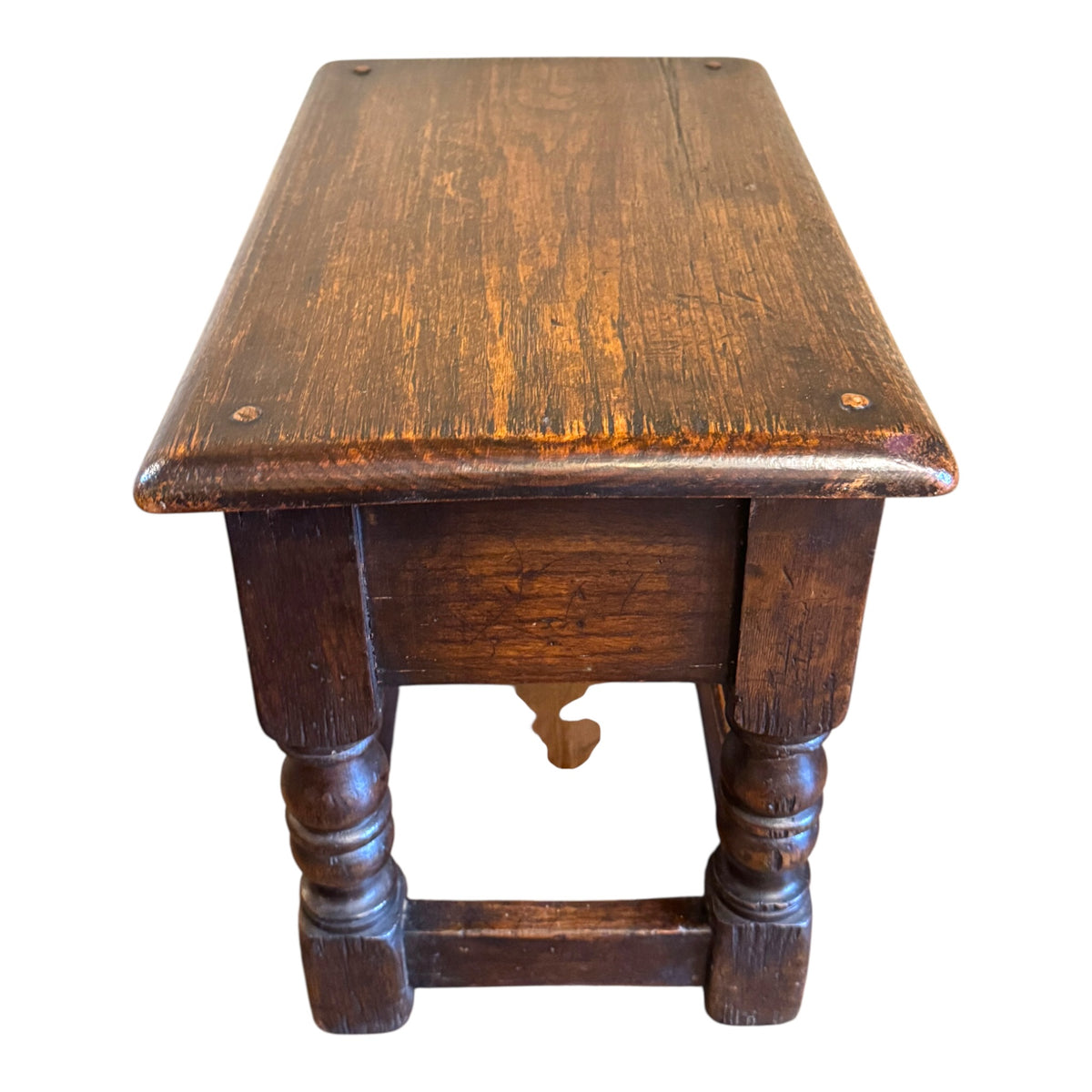 Top view of antique oak joint stool showing heavily aged surface, softened edges, scratches and natural patina