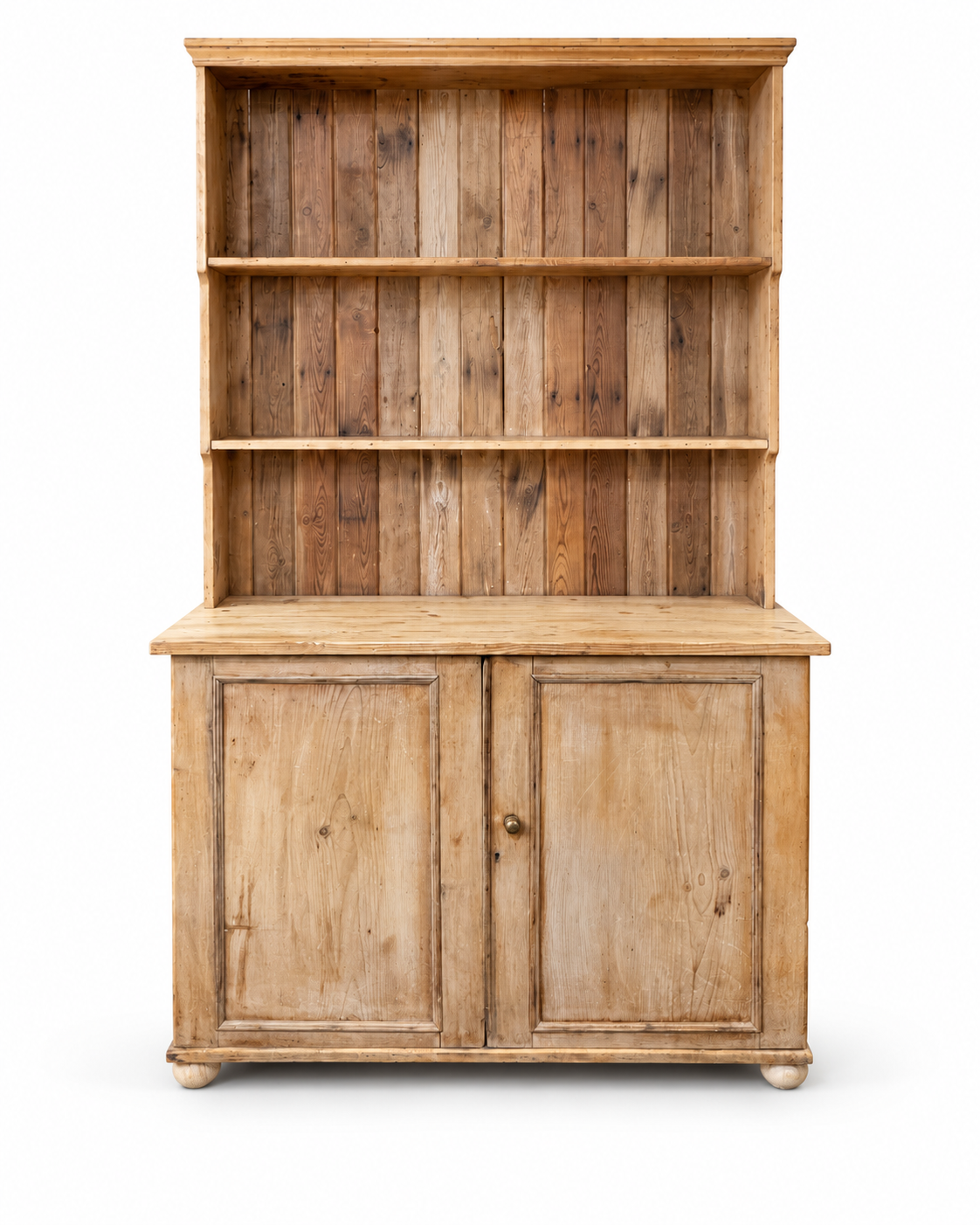 Antique pine kitchen dresser isolated on a white background showing full front view, open shelves and two-door cupboard base.