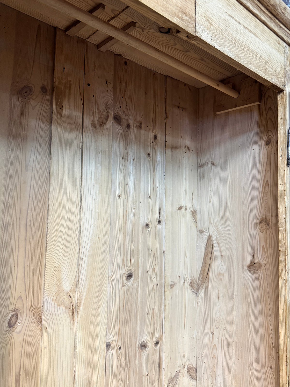 Wide boarded pine interior of antique Victorian wardrobe showing traditional solid timber construction