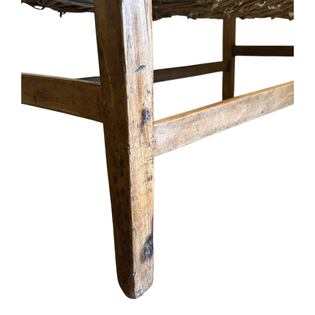 Close-up of woven rush seat, aged walnut leg and traditional frame construction on antique c.1900 settee