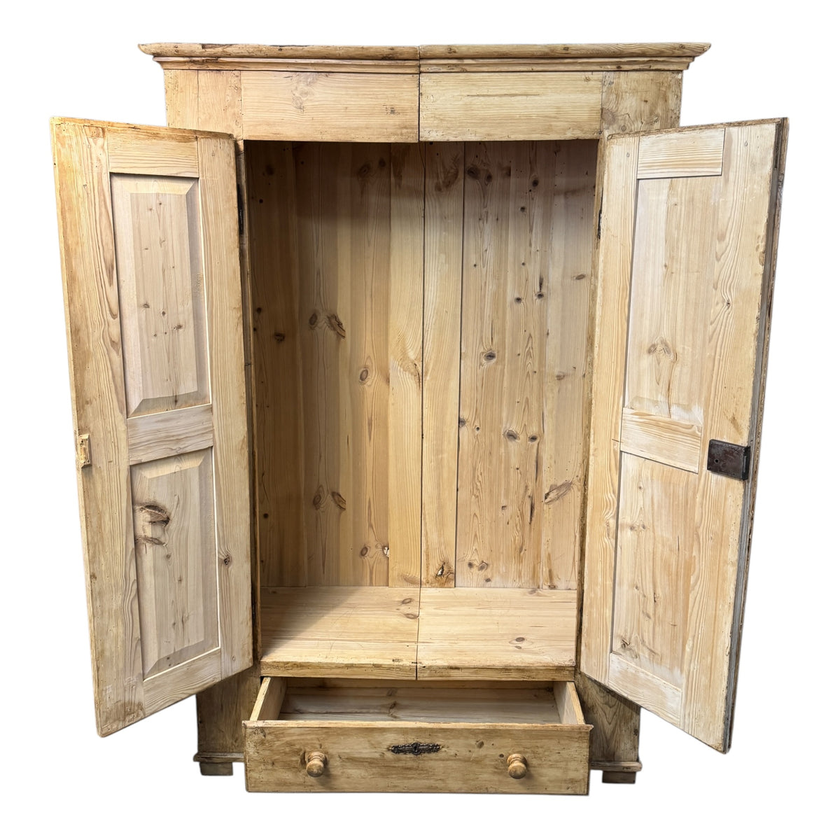Antique Victorian pine wardrobe with both panelled doors open, revealing the boarded interior and lower drawer