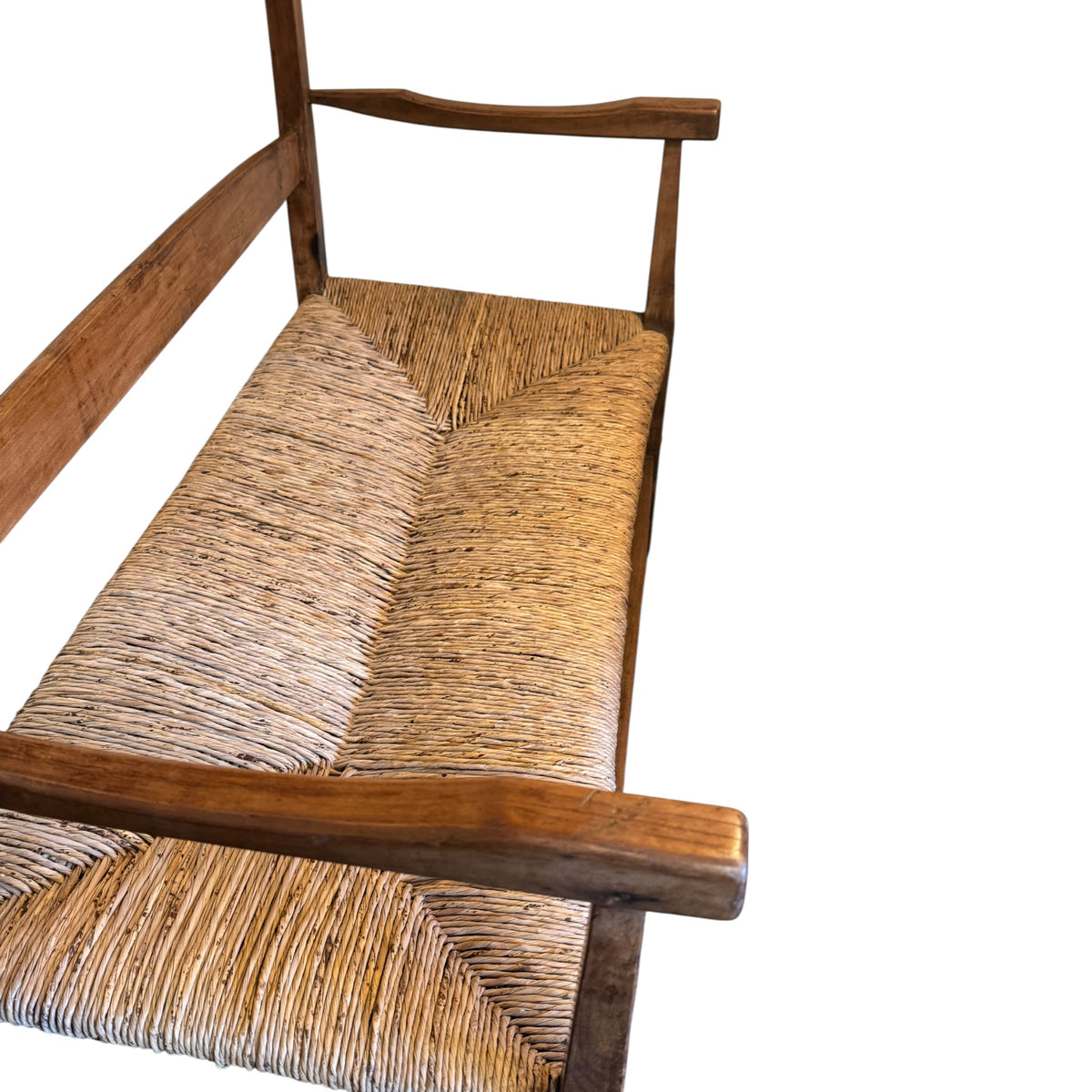 Hand-woven rush seat and sculpted walnut arms on English Arts & Crafts two-seater settee dating to circa 1900