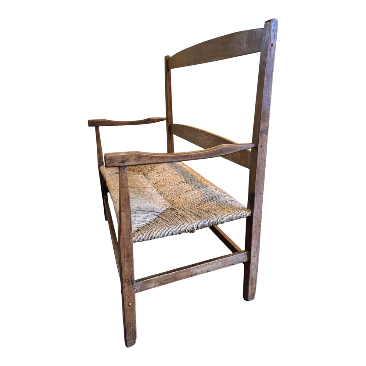 Angled view of antique c.1900 walnut and rush two-seater Arts & Crafts settee showing shaped arms and pegged frame