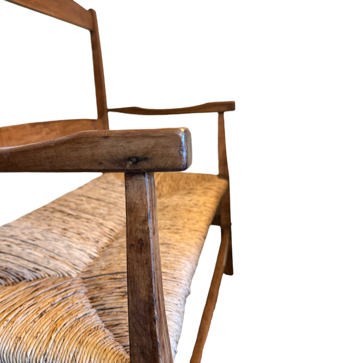 Close-up of elegantly shaped solid walnut arm with original aged surface on antique Arts & Crafts two-seater
