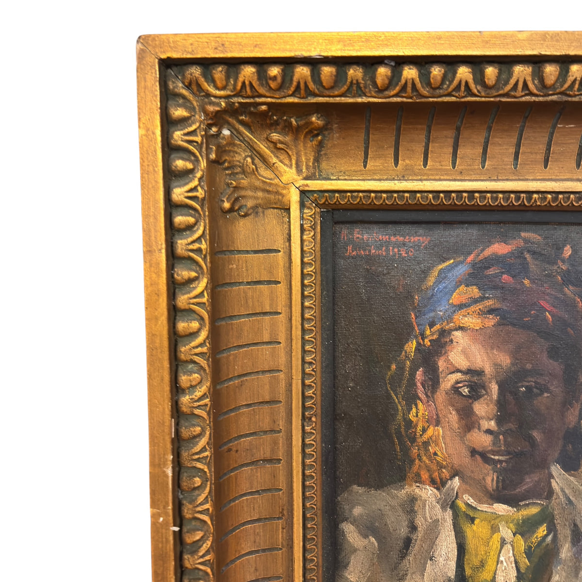 Detail of the sitter’s colourful headwrap and face, with the signed upper corner and decorative gilt frame