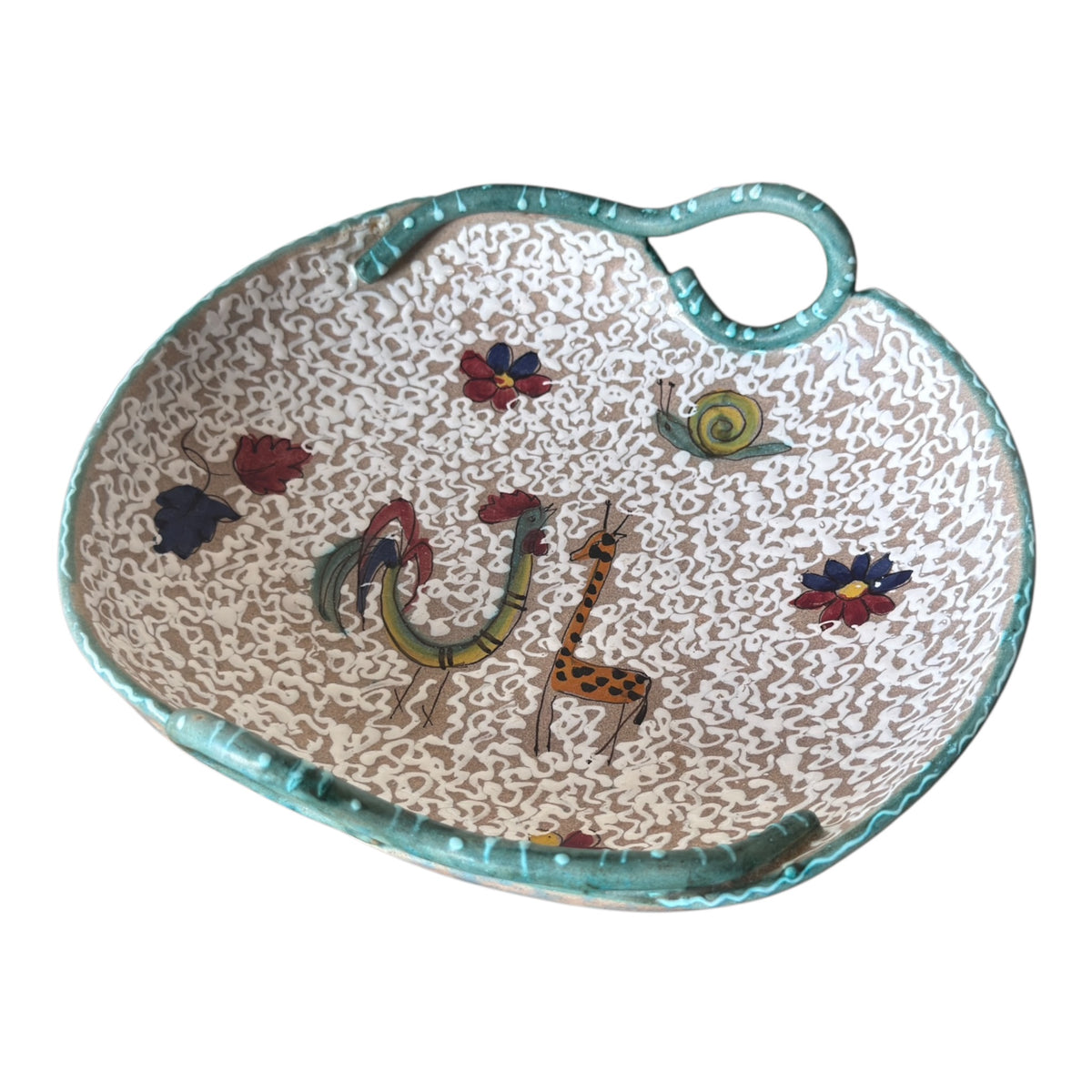 Angled view of ARS Artigiana Deruta Italian pottery bowl with raised white slip decoration and animal motifs