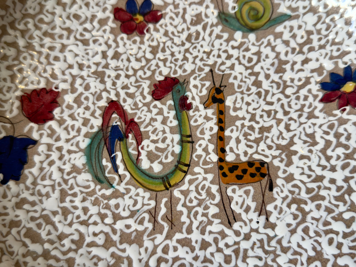 Close-up of hand-painted giraffe, cockerel and snail motifs on ARS Artigiana Deruta pottery bowl
