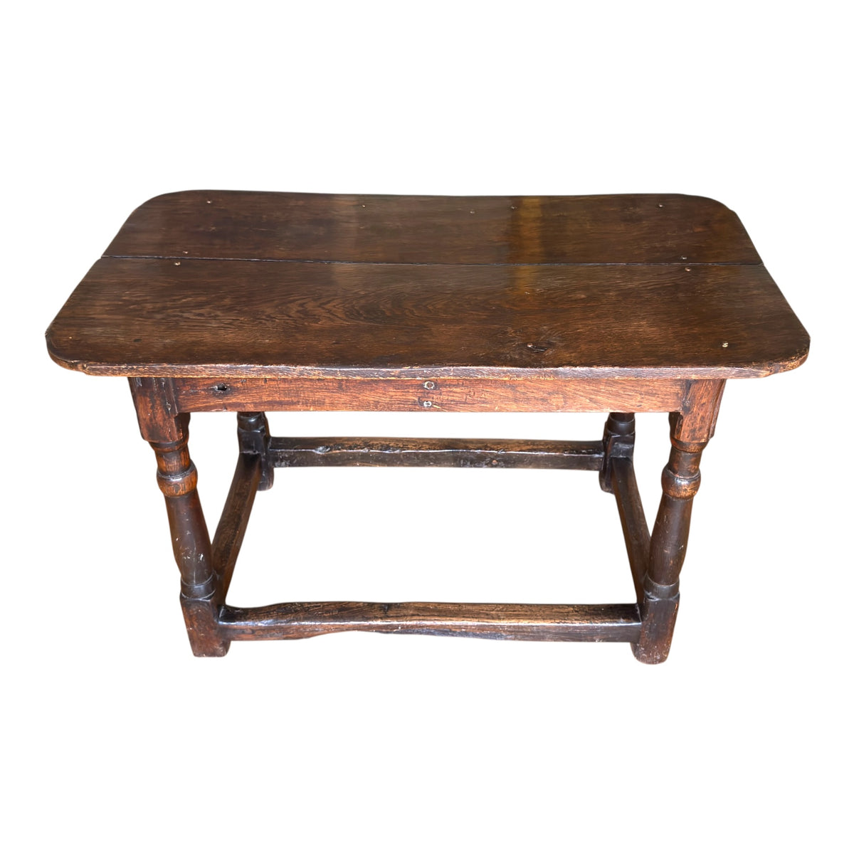 Elevated view of the late 17th century oak tavern table highlighting the aged two-plank top, visible fixings and naturally worn surface.