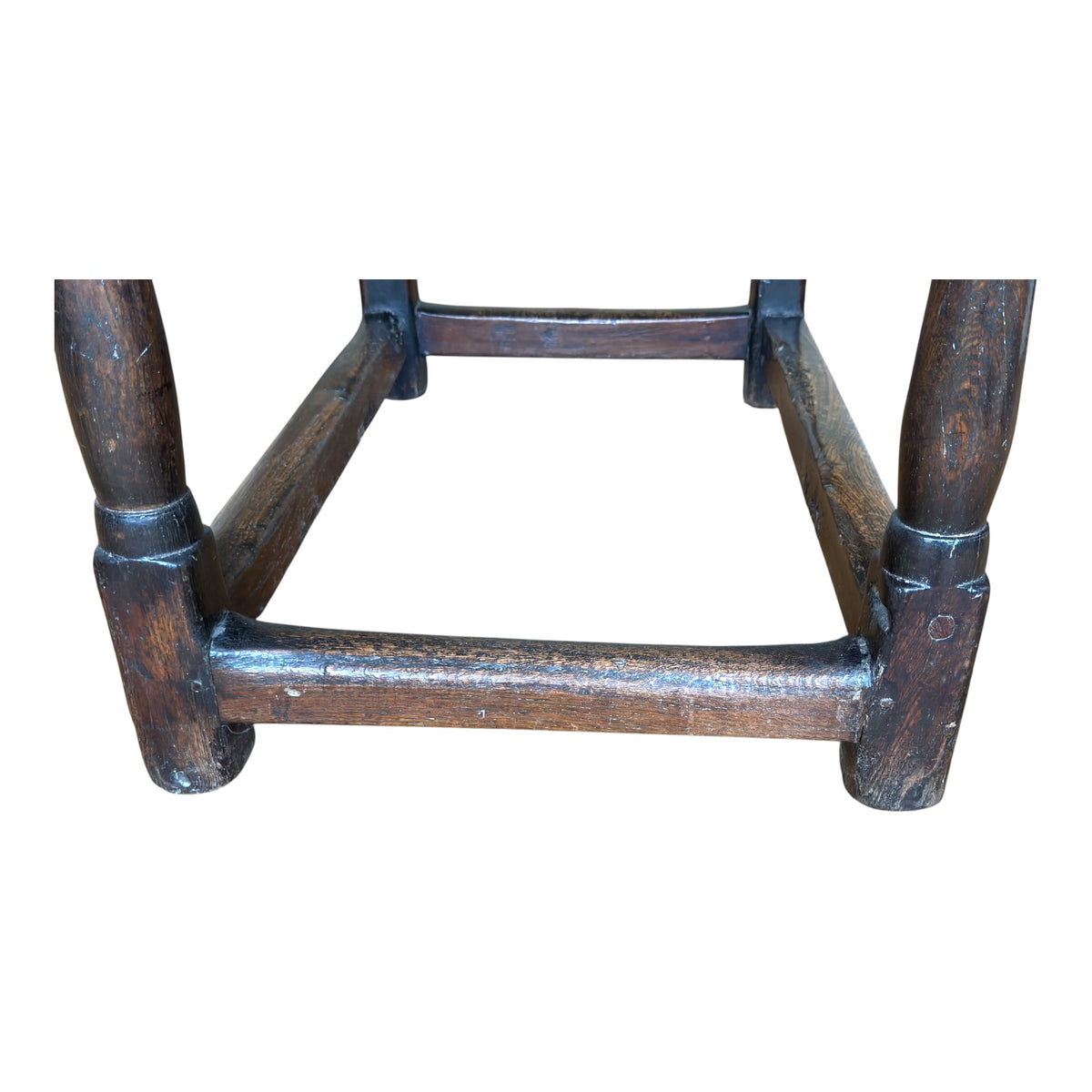 Close-up of the low oak stretcher showing pronounced historic wear, surface erosion and the naturally aged character of the timber.