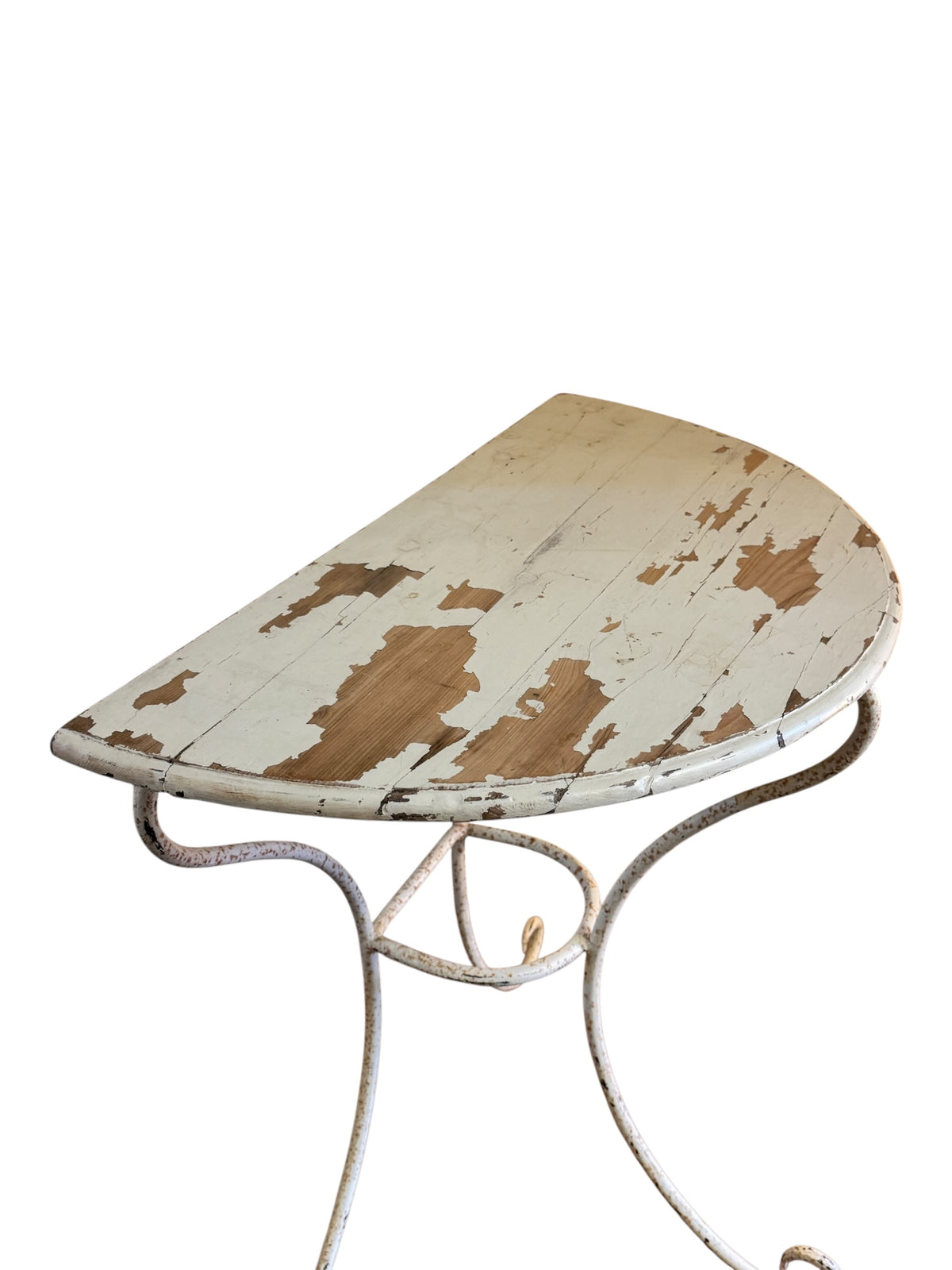 Close-up of distressed cream painted pine table top with extensive natural paint loss revealing warm timber beneath.