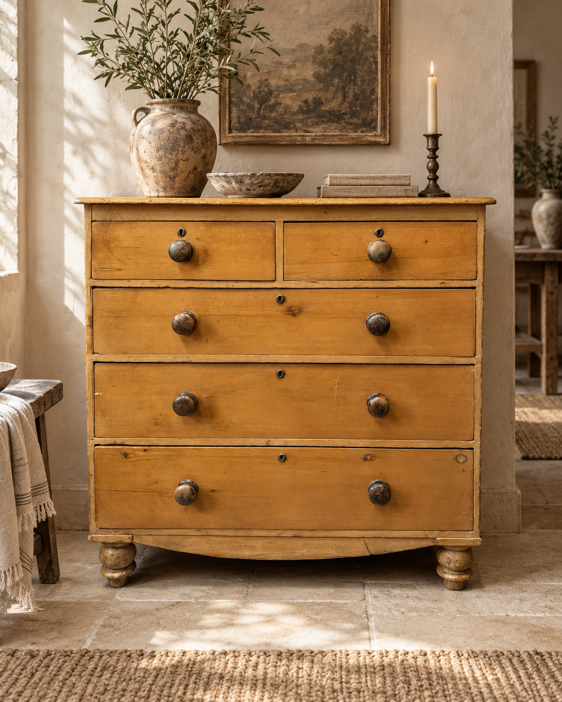 19th century Victorian pine chest of drawers styled in a warm neutral interior with limestone flooring and limewashed walls.