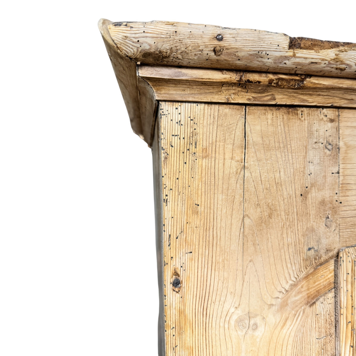 Close-up of the projecting moulded cornice and aged pine surface on a late 19th century wardrobe